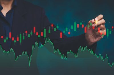 Businessman analyzing stock market chart with candlestick graph, concept of finance, investment, trading, risk management, and economic growth.
