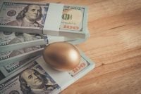 Bright golden egg and US dollar bill cash banknotes background. Rich, wealth, successful from stock dividend in stock market investment. Business, financial, investment and retirement planning concept