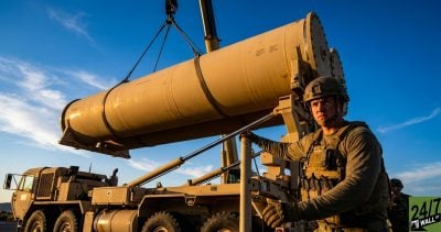 The low-angle perspective makes the missile canisters appear looming and powerful, emphasizing the scale of national defense readiness and the massive physical size of the stockpiles being replenished.