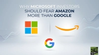 A graphic with the title 'WHY MICROSOFT INVESTORS SHOULD FEAR AMAZON MORE THAN GOOGLE'. The Microsoft logo (four colored squares: red, green, blue, yellow) is on the left, and the orange Amazon smile/arrow logo is on the right. Below, the colorful Google 'G' logo is positioned centrally. The background is a light grey with subtle, abstract blue-grey wavy lines, suggesting data or market trends.