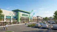 A bright, high-angle view of a bustling modern retail shopping center featuring a large green-accented grocery store named 'GROCKEYTORT GROCERY' and several smaller shops. Shoppers are visible on sidewalks and in a busy parking lot filled with cars. Large translucent green arrows pointing upwards with stacked dollar signs are overlaid on the buildings, indicating financial growth.