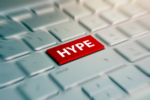 HYPE - red Button on grey Computer Keyboard. blurred in motion background.