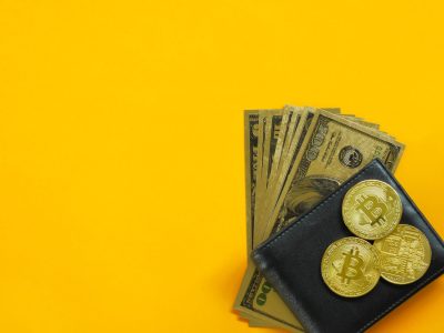 gold bitcoins in black leather wallet