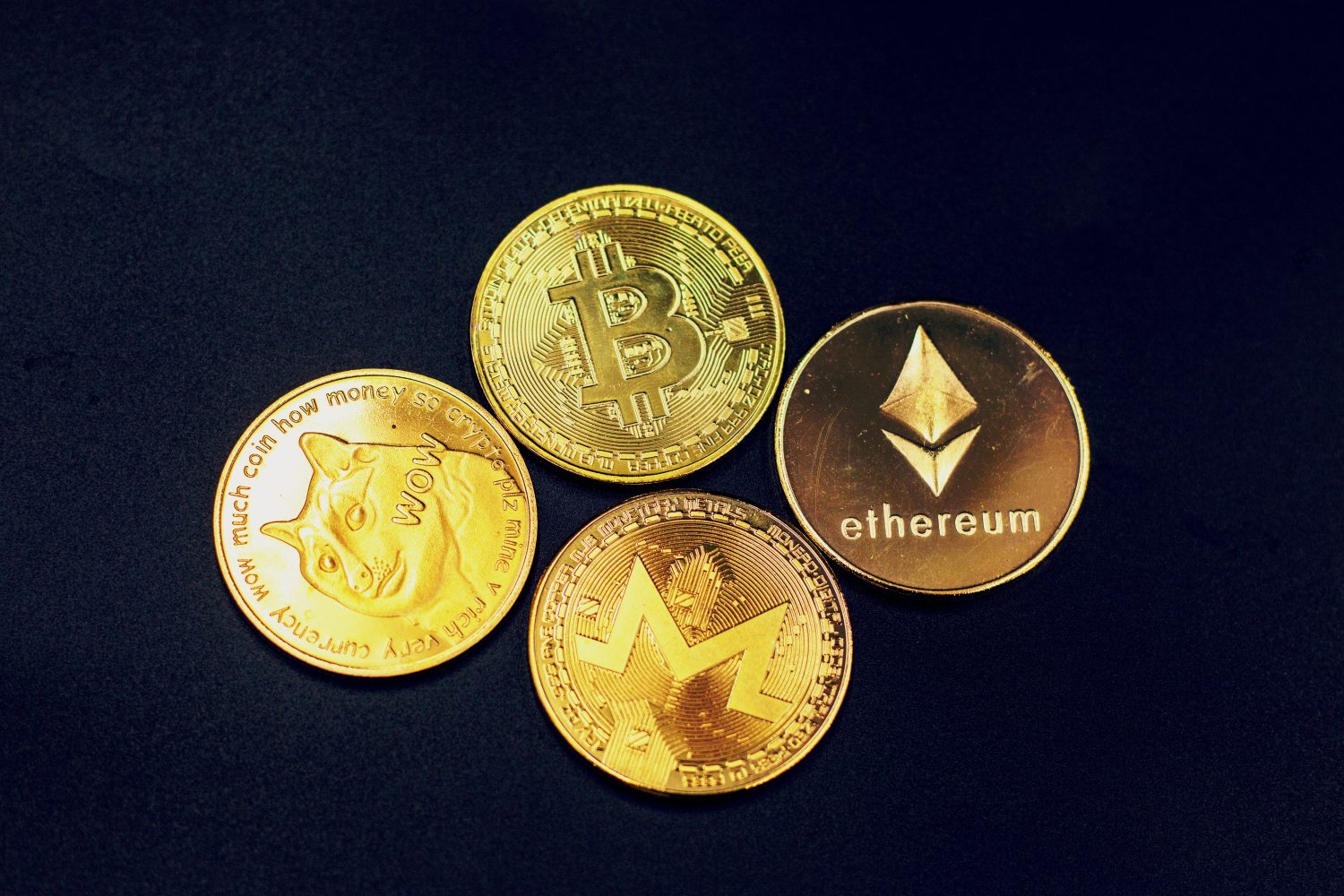Dogecoin bitcoin Ethereum and Monero coin are on black background