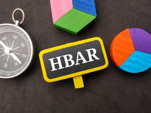 Compass,colored wooden cube and wooden board written with text HBAR on a black background.
