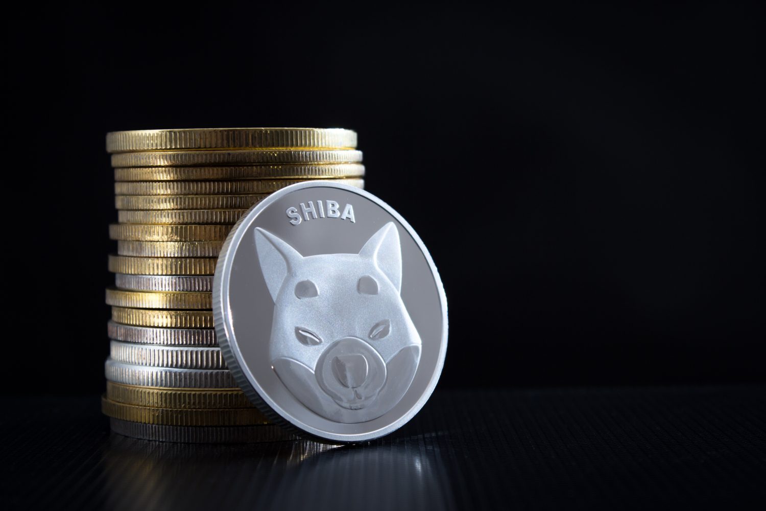 Stack of shiba INU coins over black background