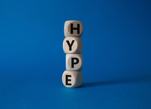 Hype symbol. Concept word Hype on wooden cubes. Beautiful blue background. Business and Hype concept. Copy space.