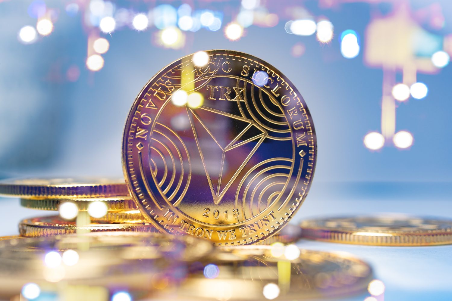Cryptocurrencies and technology.TRX Tron gold coins on futuristic and abstract background. Finance and investment concept.
