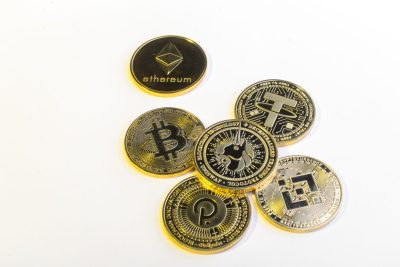 Uniswap coin on a white background. Physical coin Uni, BNB, BTC, DOT, ETH, USDT on a white background.