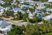 Premium housing development in the USA. Expensive houses between green palm trees in southwest Florida