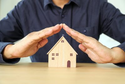 Financial planning for home loan concept hand and house for plan of money savings management for buy housing residential or family insurance or banking agreement.