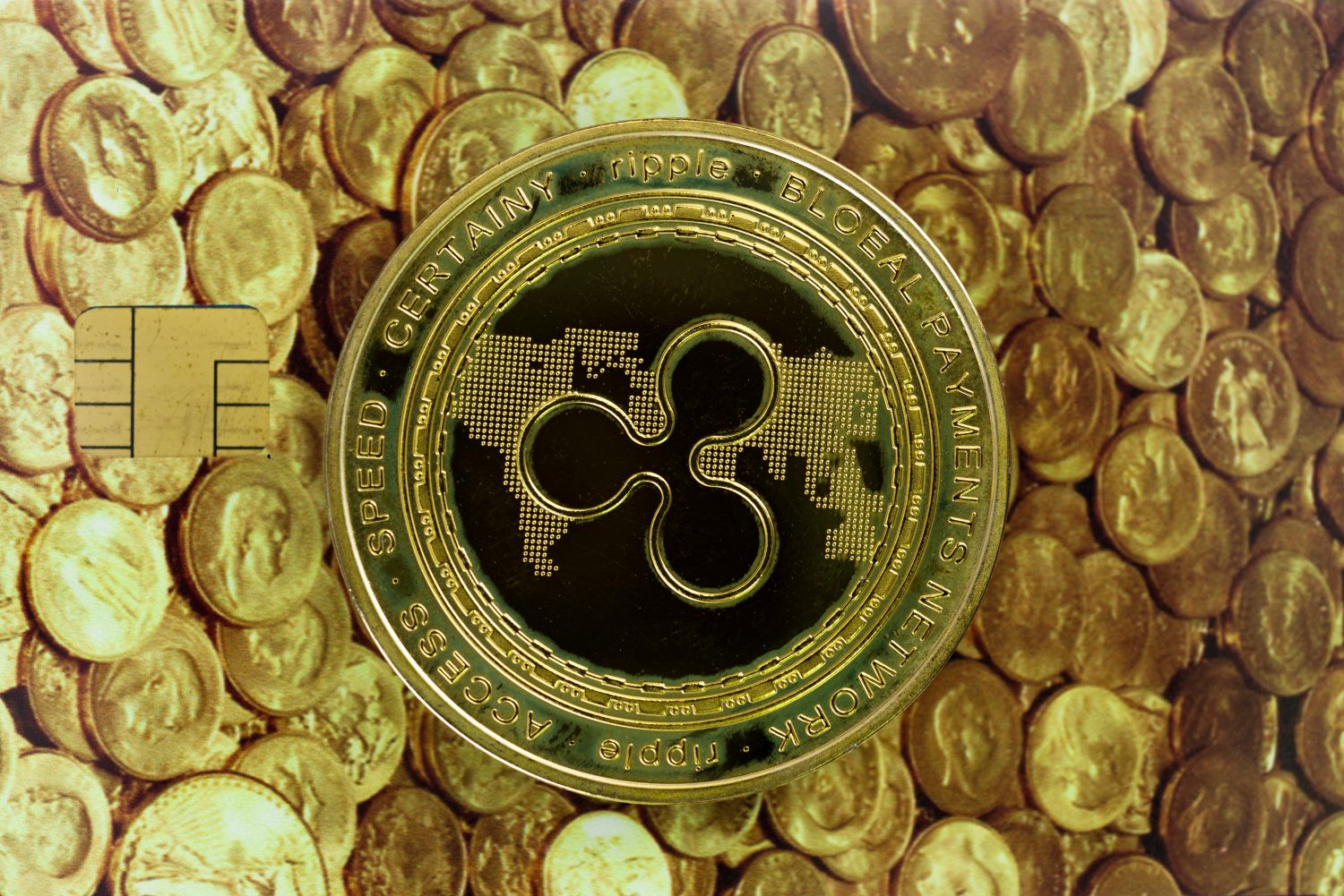 Cryptocurrency concept. A close up shot of Ripple XRP cryptocurrency coin on top of a credit card with a picture of ancient gold coins. selective focus in the center.
