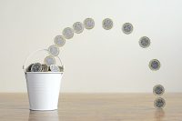 Pound Coins Filling A Metal Bucket. Saving Money Concept.