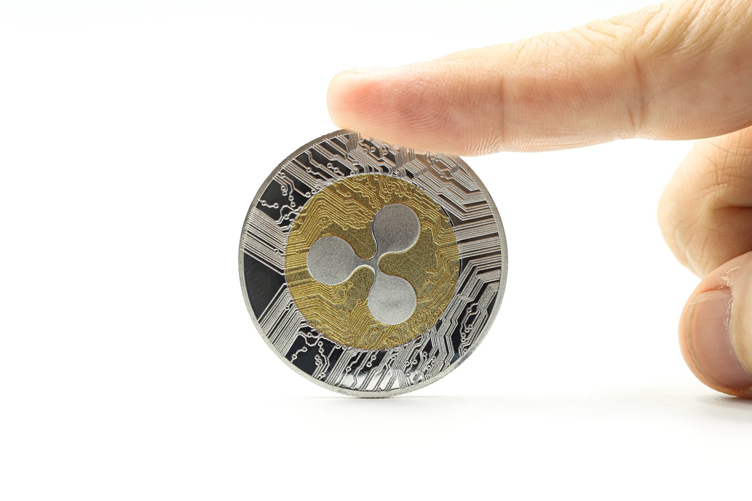 Hand holding a cryptocurrency of Ripple XRP. Space for text.