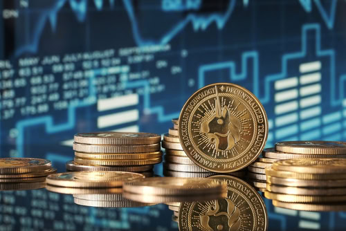 Golden Uniswap coins are displayed in front of green and blue financial graphs representing market trends and cryptocurrency fluctuations in a modern setting.