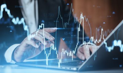 Businessman interacting with digital stock chart interface, modern creative style, blurred office background, concept of market analysis and forex