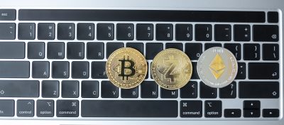 golden and silver Cryptocurrency on keyboard laptop, Bitcoin , Ethereum, Zcach coins. Crypto is Digital Money within the blockchain network