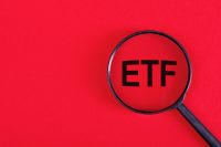 ETF analysis concept. Word through magnifying glass. High quality photo