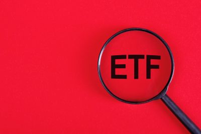 ETF analysis concept. Word through magnifying glass. High quality photo