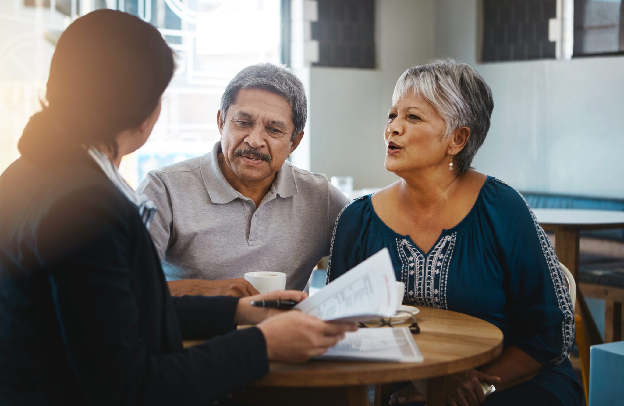 Senior couple, talking and lawyer with documents for financial advice, retirement plan and will at home. Old man, elderly woman and attorney with paperwork, bud