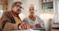 Laptop, finance and senior couple in home for budget, pension and mortgage payment. Retirement, taxes and man and woman with paperwork for life insurance, investment and bills for online banking