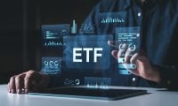 Man interacting with digital ETF dashboard showing futuristic financial charts and data, modern interface on a dark tech-themed background