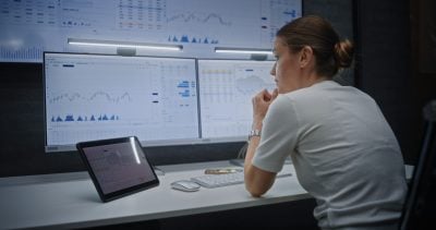 Female Stock Exchange Broker Having Phone Call, Soaking Financial Loss, Monitoring Exchange Market Charts on Multi-Monitor Computer and Digital Tablet. Investment Agent Stressed About Bad Economy News
