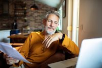 Mature man working from home with laptop