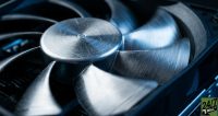 The macro detail of a high-speed cooling fan creates a sense of motion and mechanical intensity, visually representing the 'heat' of the AI race without using tired metaphors.