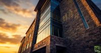 Using a low-angle, heroic shot of a premium commercial retail asset creates a sense of 'tangible wealth' and institutional stability that stops the scroll for investors tired of abstract charts.